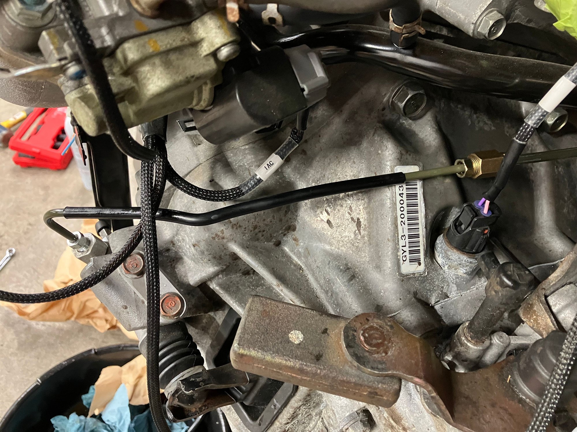 Clutch line is connected and bled. The MINI OEM clutch line has a type of quick disconnect fitting that makes adapting it kind of difficult. The solution I found was to get a MINI clutch line off of an S MINI that has the female end of the quick disconnect, use a brake line cutter to cut the end off, slide the correct sized brake line fitting on and then flare the end. Then I basically did the same thing to the Honda side. OEM 2003 Honda Accord clutch line. Then I just joined then with a fitting