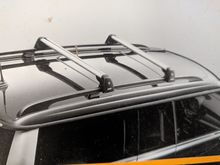 Photo from the manual.  shows where the cross bars mount to the integrated roof rails.