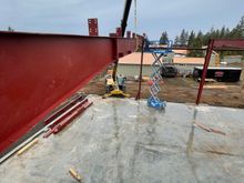 I am a part of the crew up high raising the roof beams. Just three of us that day.