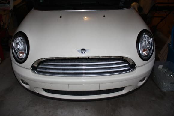 Painted the headlight trim. Was originally chrome. I'm now working on the grill.