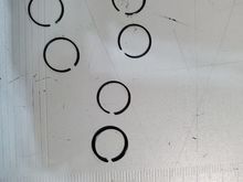 You can see the size difference in the wire diameter of the spring clips. Upper original, lower the replacement