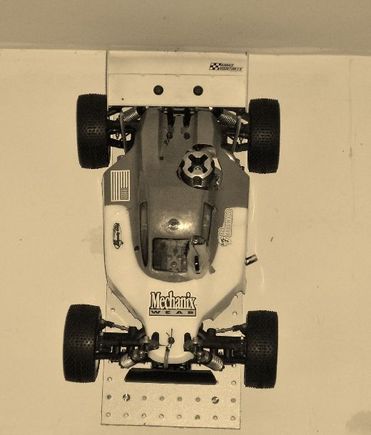 002 (2) (520x610) Retired DuraTrax Axis buggy from '04-'05 THRC season. Wall-mounted display photographed in sepia tone.  P-L Crime Fighter tires.