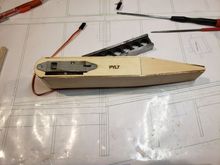 Spritz water on the sides then glue in place. Then add a piece of filler (behind PYL7) and install the payload release.