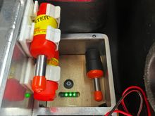 The 12 volt 12 AH battery in my flight box is a very lightweight, Lithium Ion motorcycle battery. It has a push button on top to activate an LED bar graph State Of Charge display. I added a few holes to the cover so I could make use of that feature.   The battery is kept topped off by connecting the power panel to the Powerpole system.