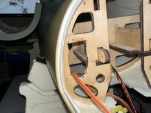 Making the rectangular opening in the oval for the nose gear door servo. 