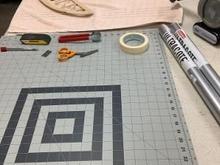 Far end covered with a towel; this is where ironing will take place. Cutting mat at near end. 