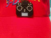 Small transmitter you can wear on your hat held on tightly by a very strong magnet.  No holes in your HAT!