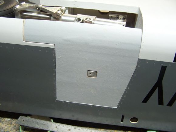 The stop on the landing gear is just about flush with the outside of the fuse. So I cut a hole in the door to start messing around with some hinging