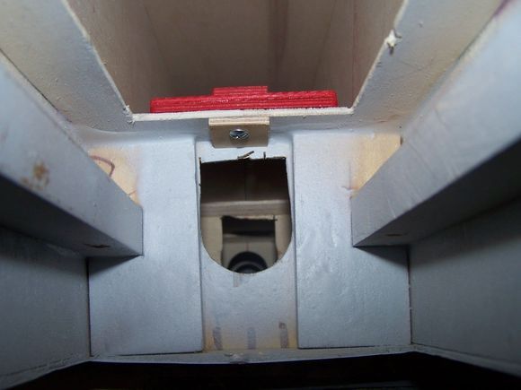 Secured with one screw under the nose retract with a plywood scab doubled under the screw head.