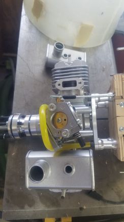 I drilled out the firewall for throttle linkage, ignition wire, and fuel line. Muffler removed to get to throttle linkage. Looks like a special muffler will have to be ordered if possible.