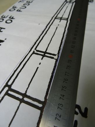 The plan is distorted. The blue Biro line to the right of the starboard longeron and to the left of the port longeron illustrate the true line. Likewise the one-metre rule.