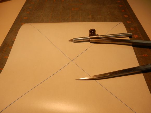 Nine inch sq. Frisket stencil paper w/ corner to corner diagonals to mark location. Locking compass w/ curved blade used to scribe a perfect circle.

