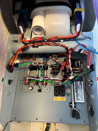 I mounted two super bright LEDs on the struts.  They require a 1S lipo to operate. That's the batt you see lower right on the equipment tray.  Behind the batt is the servo operated switch to the lights turn on and off.  Once I see the locks are engaged I will turn them off to save the batt for lots of flights.  I found I'd get about 30 minutes of lighting with them on steady so I'll have plenty of capacity even if I leave them on a lot.