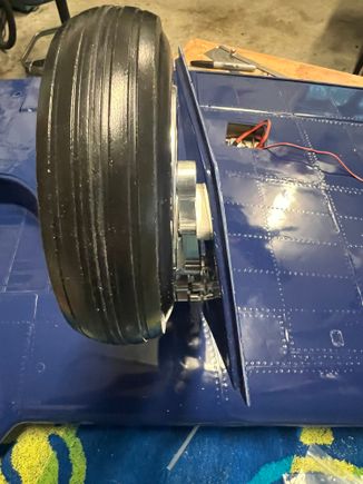 Here you see the rather extreme angle of the doors to the strut/tire.  This is built into the design and can't be helped.  The aluminum wedge securing the bottom of the strut to the door angles both side to side and top to bottom!  Was a fun bit of machining.