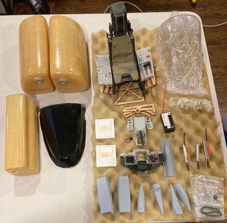 2 x 68oz Kevlar fuel tanks + secondary (fuel/smoke) tank (estimated 30oz), windscreen, instrument panel, scale cockpit kit (removeable), scale details, air cylinders.  Hardware bags (bolts, fittings, etc, not shown)