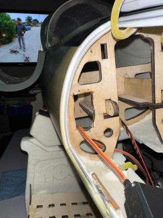 Making the rectangular opening in the oval for the nose gear door servo. 