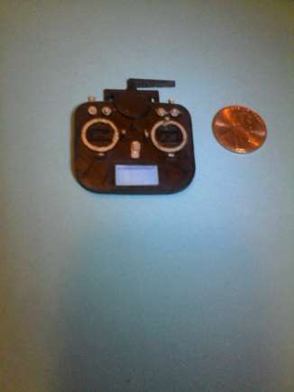 Compare the size of the transmitter to the new penny laying beside it.