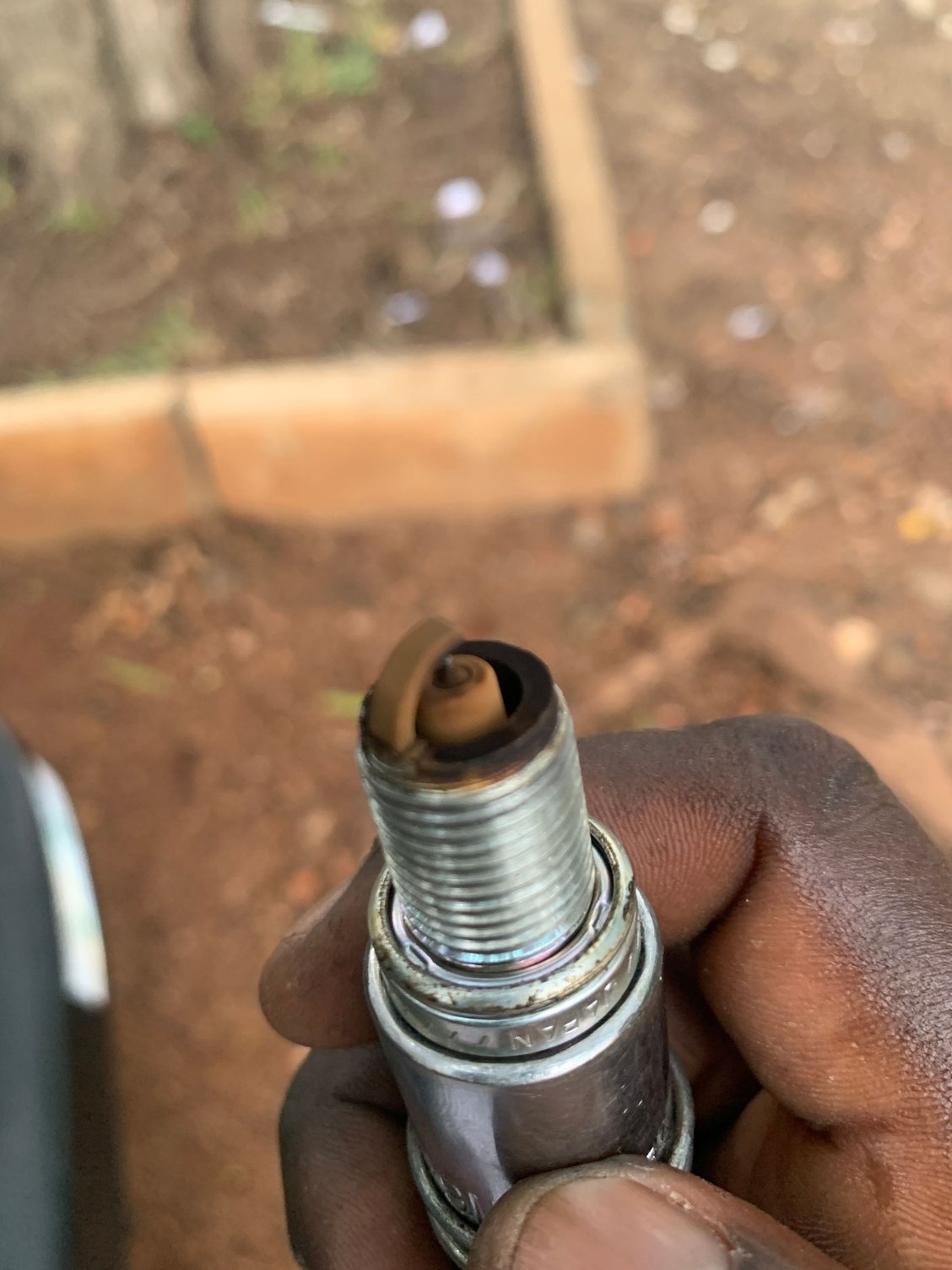 Half white, half black spark plugs. What does this tell you?