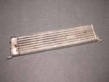Secondhand RX7 GSE-SL oil cooler. I couldn't locate a good 40 year old secondhand unit to replace the new one in the coupe.  The OEM oil coolers always keep the car cool.