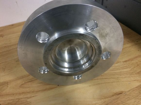 The tricky part was this wheel spacer . The inner part centres to the rx7 hub. The outer ring centers the Porsche rotor which has a large center hole. The other side of this spacer has a raised center to center the wheel . 3.25 inch long arp wheel studs were required as well.