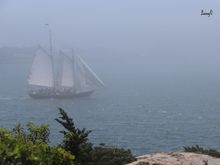 Sailboat in the fog off of Jamestown, RI.  View from a fort on the island.