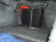 Passenger side trunk battery relocation