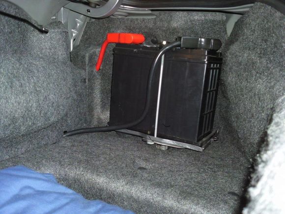 Passenger side trunk battery relocation