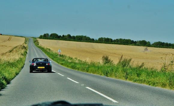 The open road in the English countryside on a perfect summer&#39;s day
