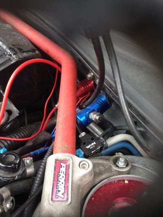showing nitrous connections to blue nitrous soloniod. T connection to right of strut bar 1. connects to soloniod. 2. runs to left and through firewall and car to nitrous bottle connection in boot. 3. runs under strut bar behind intercooler into car on driver side to nitrous pressure gauge.