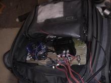 IMAGE 003

Riding in the tank-bag on its early test. 
Yes, thats a peice of wood its mounted on.
Melted some wires when I rode it fast, but it proved the early circuit design, and got me the patent.