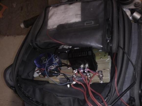 IMAGE 003

Riding in the tank-bag on its early test. 
Yes, thats a peice of wood its mounted on.
Melted some wires when I rode it fast, but it proved the early circuit design, and got me the patent.