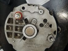 Remove the four bolts on back to open the two sides of the housing. Take note of the "clocking" as this can be changed id you don't pay attention.  Clocking refers to the position of the plug relative to the threaded mount.  In this case, my alternator is at 3 o clock.  (Not well shown in pic)
