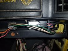 Silver box is the rear defrost relay, the antenna relay is on the left.