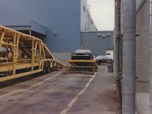 Sport coupe on ramp to be loaded out back.