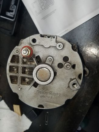 Remove the four bolts on back to open the two sides of the housing. Take note of the "clocking" as this can be changed id you don't pay attention.  Clocking refers to the position of the plug relative to the threaded mount.  In this case, my alternator is at 3 o clock.  (Not well shown in pic)