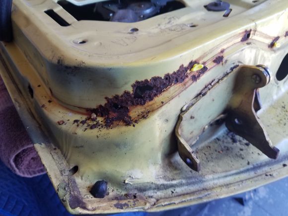 Odd spot for rust to form.  I think water got trapped behind the weatherstripping.