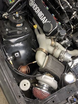 New position bent forward more and attached to front subframe