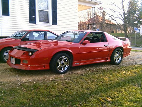 pic from 2002. Chrome factory wheels and a stupid bra thing. headlight housing was red from previous owner.