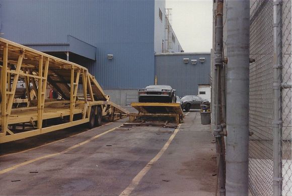 Sport coupe on ramp to be loaded out back.