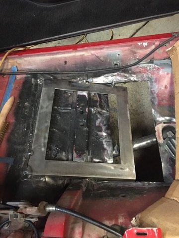 Floor cut out, new seat frame tack welded in. 