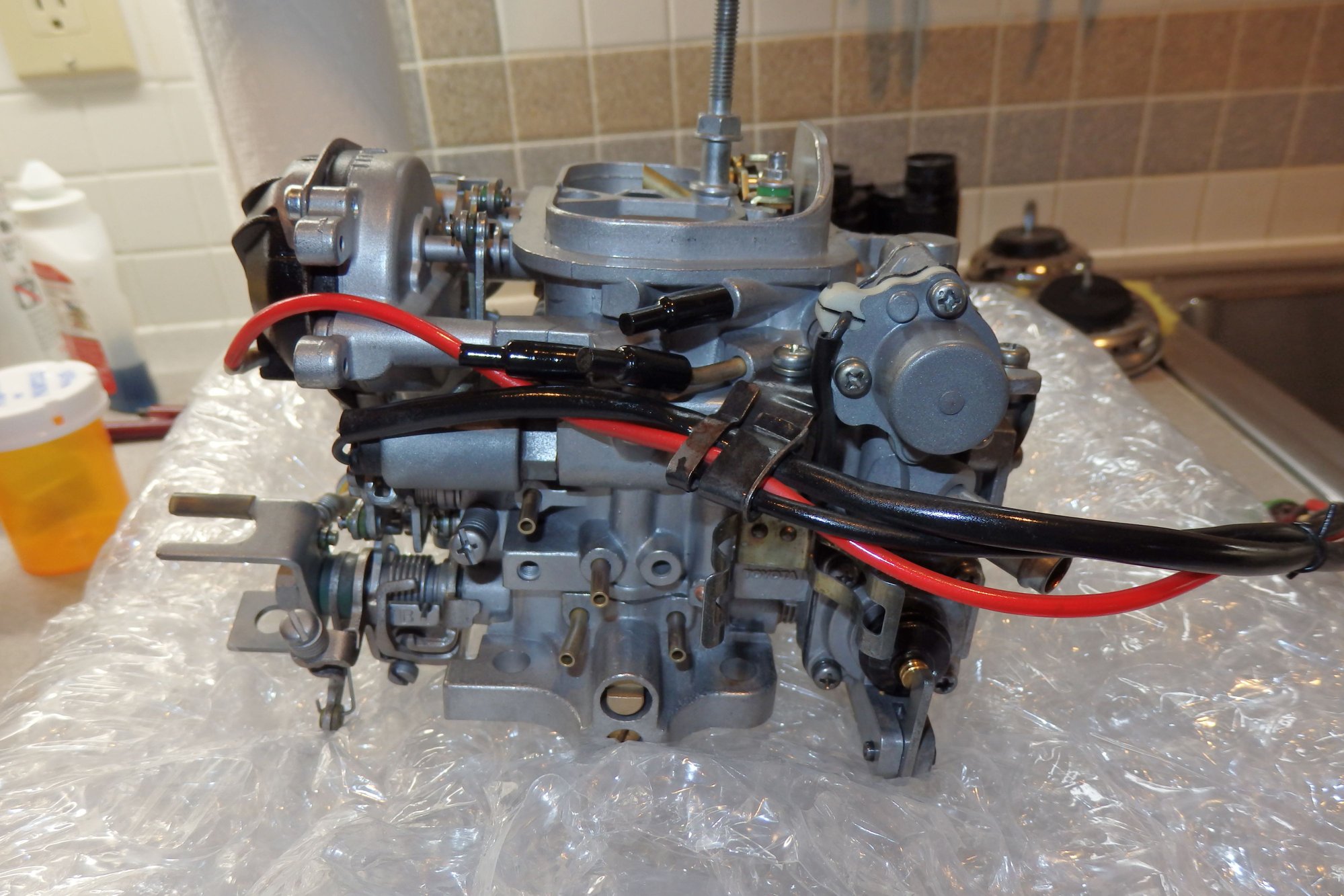 Passenger side, vacuum connection in question is lower right of four on this side (all look to be same size)