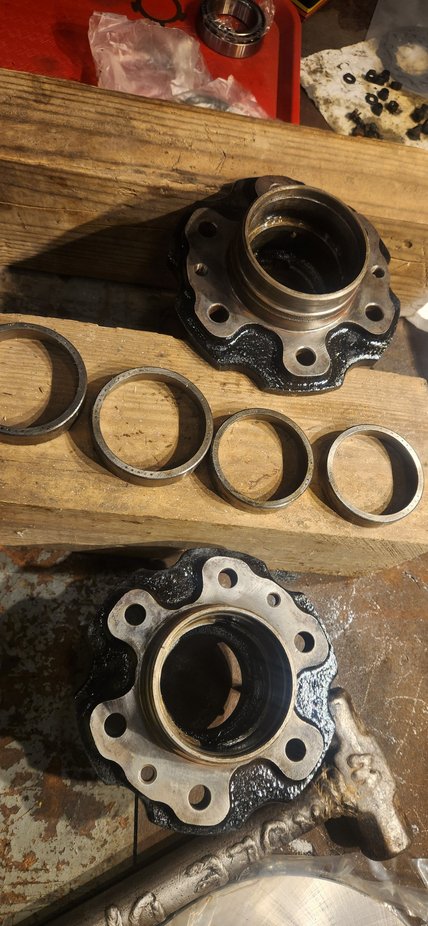 Blocks of wood or in a vice to hold them up. The hubs have two knotches on either side where you can catch the inside edge of the race with a brass punch.  