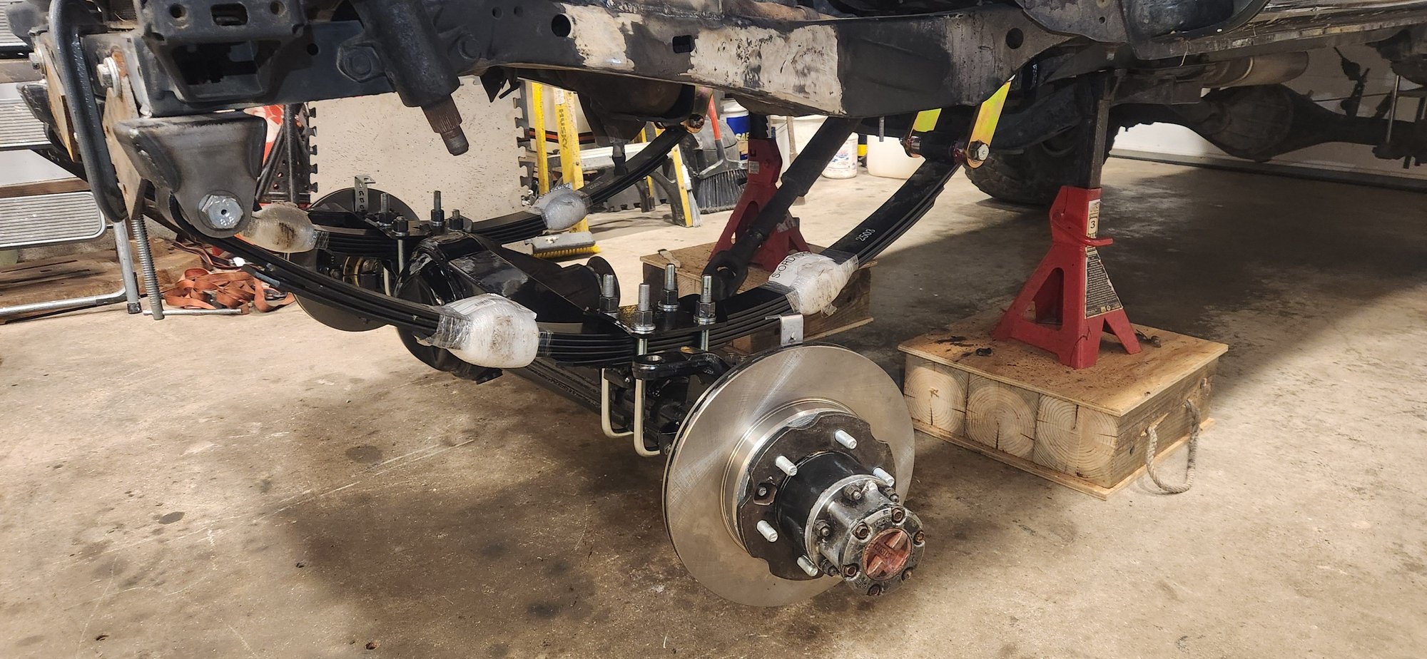 This photo feels like a misrepresentation with the time involved to get the bushings,shackles,leaf springs,axle all bolted together. Had the axle on a small cart, fortunately the truck was already high enough to roll it under the springs. Getting the axle high enough to catch the ubolts, and get the leaf spring pins lined up definitely takes a little bit.