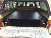 Killz brand latex primer, few coats of black. One long compartment on the left. Split compartment on the right. on the cab end of the bed is a metal box 10" high which supports the platform when at full length perfectly.