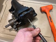 Remove top 4 bolts and one nut. Turning the screw clockwise will push the top cover off.
