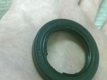 I'm guessing the 1/4" play in the crank from the front to the back from the loss of the thrust washers also caused this seal in the transmission to go bad.