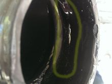 crack shown in yellow  circle, but filled in with Shoe Goo