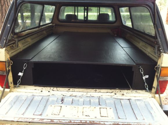 Killz brand latex primer, few coats of black. One long compartment on the left. Split compartment on the right. on the cab end of the bed is a metal box 10" high which supports the platform when at full length perfectly.