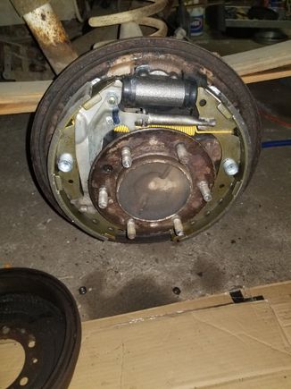 Axle reinstalled, brakes reconnected. Just need to install the drum, adjust the shoes and then bleed.

Now I'm fighting to get my other rusty drum off so I can do those shoes and hardware..