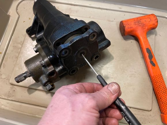 Remove top 4 bolts and one nut. Turning the screw clockwise will push the top cover off.